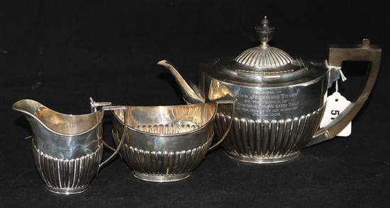 A three-piece silver tea service, of oval half-fluted form, Goldsmiths & Silversmiths Co. Ltd, 28.6oz